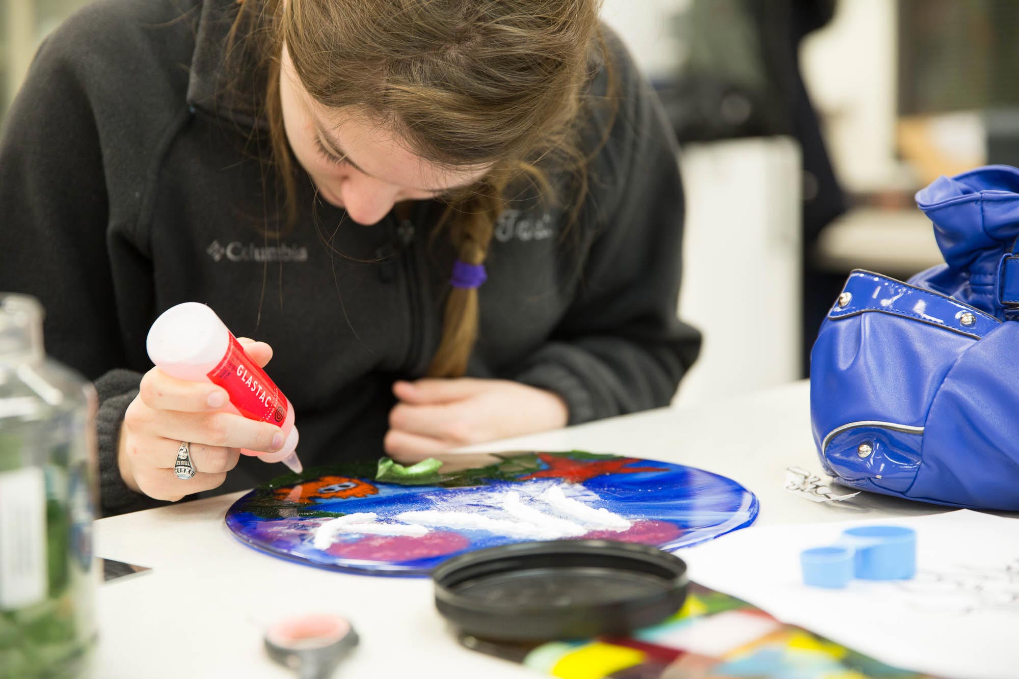 Student painting in a classroom